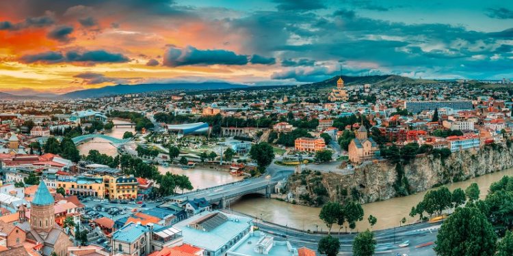 Tbilisi, Georgia. Panorama Cityscape Of Summer Old Town. Metekhi Church Of Assumption In Historic Neighborhood Of Tbilisi During Beautiful Sunrise. Central Part Of City With Famous Landmarks.